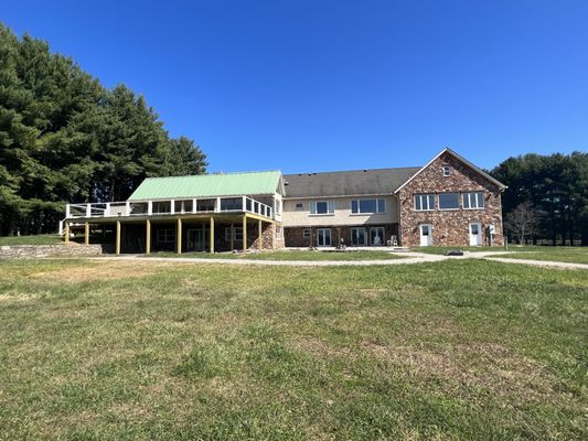 back of the winery, there is outdoor seating on the deck.