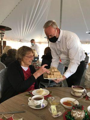 Pastor Roger serving at the 2021 Women's Tea Party.