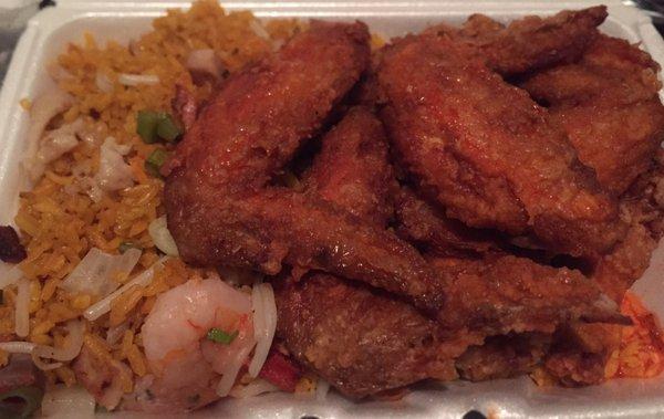 Chicken wings with hot sauce over house special fried rice