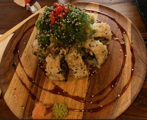 Fantasy Vegan Roll. Beautiful and yummy. Asparagus and cucumber roll with tempura mushroom and seaweed salad on top.