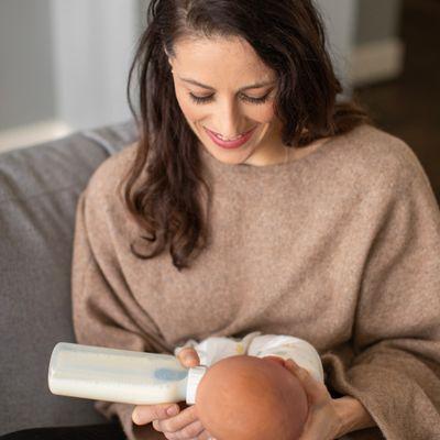 Jean demonstrating how to feed a newborn with the bottle