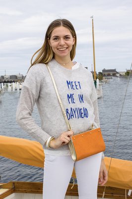 Our gorgeous LIzzie clutch/crossbody bag with an reversible Italian leather and silk cover shown with our Meet me in BH cashmere sweater.