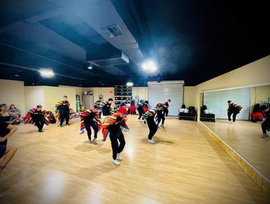 Men dancing with zarapes at Arizona Folklorico Dance Studio in Tucson, AZ as part of their Mexican folklorico dance lessons