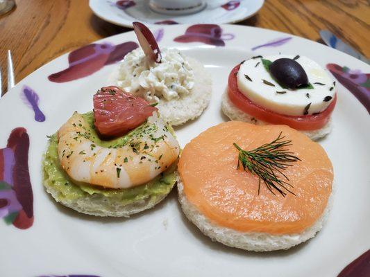 Tea sandwiches - angle #1,: salmon, shrimp with avocado & grapefruit, goat cheese with grape, caprese