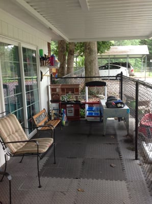 Covered front, fenced area for outside play when it's raining.