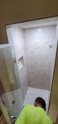 Candy's walk in shower. Pebble tile floor, porcelain tile, niche for soap bottles, shower pan, shower controls, recessed Lighting