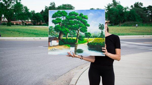 Holding a painting from Jacmel, Haiti at the Room to Roam Art Walk in 2017