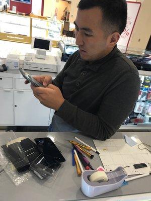 My broken screen and the guy fixing up my phone