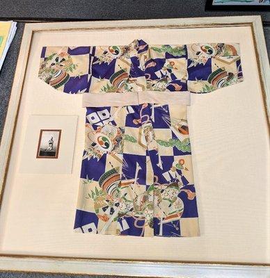 We have framed all sorts of things.  This is a child's kimono with a photo of the child wearing it.