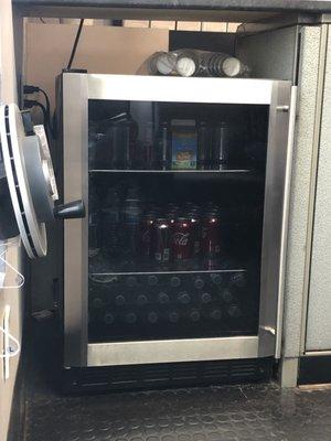 Nice, clean beverage fridge in waiting room stocked with items. Working tv, comfy seats.