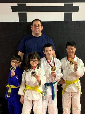 Coach Aaron Cote with Sen-I-Judo competitors