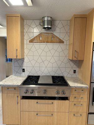 Notice small tile pieces above and below wood backing for vent hood