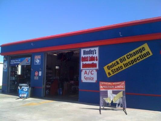 Look for the bright blue building! Sign says "Woodley's Quick Lube & Automotive".