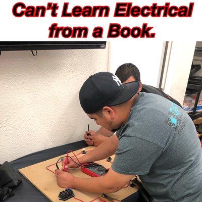 Students learn how to apply their electrical knowledge to real world situations.