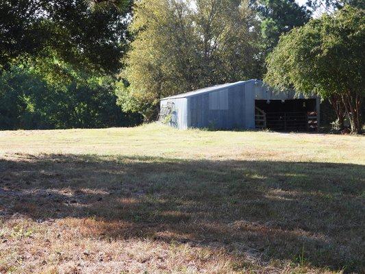 Barn on wooded property for sale near the Sam Houston National Forest.