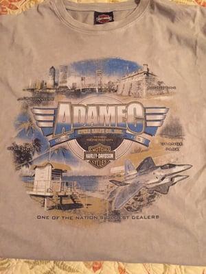 Tshirt depicting Jacksonville skyline, St Augustine fort, beaches and our Navy fighter jets along with Adamec dealerships