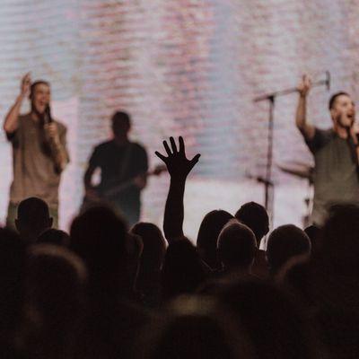 Someone responding in worship during a Sunday service.