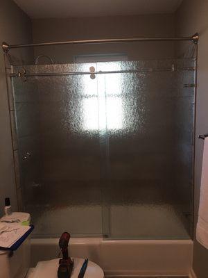 Frameless sliding shower door with rain glass