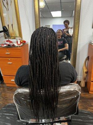 Cornrolls in the front and individual braids in the back