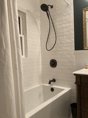 Removed blue shower/tub combo and replaced with new tub and tile.