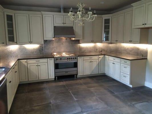 Custom Steel Backsplash, concrete tile, commercial range, & custom cabinetry