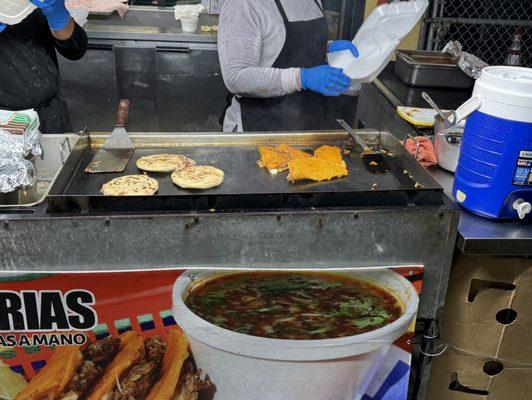 Quesabirria and pupusas being cooked to order