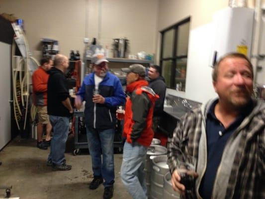 Customers milling around the brewing equipment