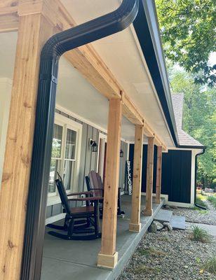 Black seamless gutters and cedar porch accents