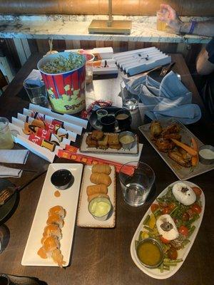 Shrimp tempura sushi, fresh truffle mozzarella salad, Asian style wings, tequenos, & mini burger sliders and of course some popcorn .