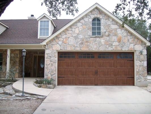 The popular Clopay Galley Series Ultra-Grain in dark oak color. These are steel garage doors but, they don't look like it!