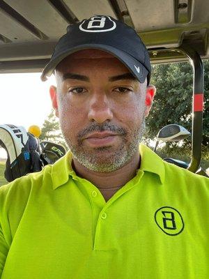 Embroidered logo golf shirt and logo hat