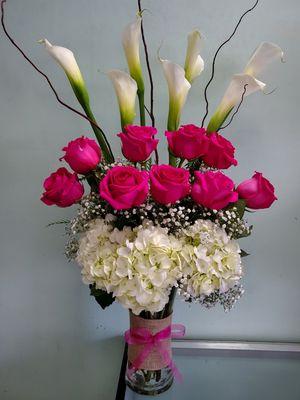 Beautiful vase arrangement with pink roses, hydrangeas, calla lillies, and twig sticks.