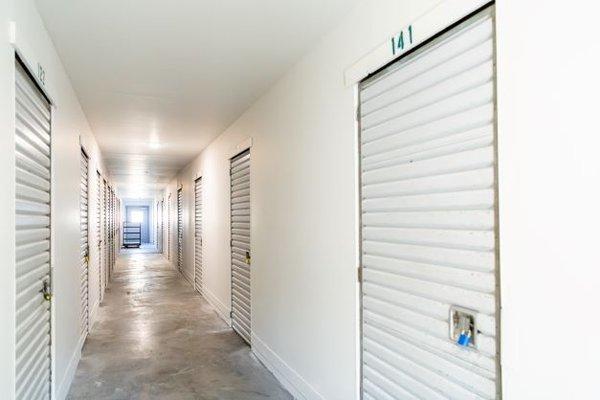 Clean, well-lit hallway storage units at Stor-All Storage in RWC