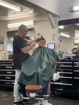 My son cutting his hair with Javier