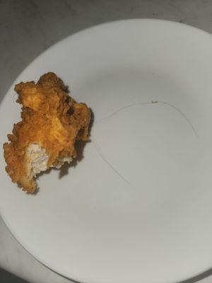 As you can clearly see there is a long dark hair attached to the chicken. The hair was tangled in the breading. Completely disgusting.