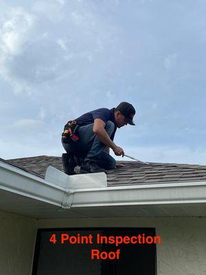 Home inspector inspecting the roof system as part of a 4 point inspection.