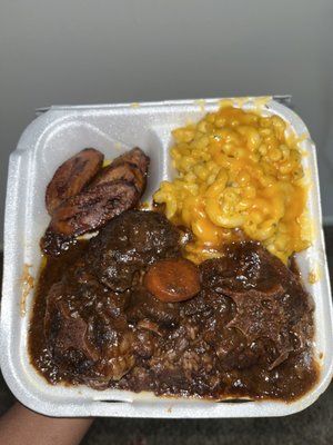 Oxtail dinner with mac and cheese and plantains sides