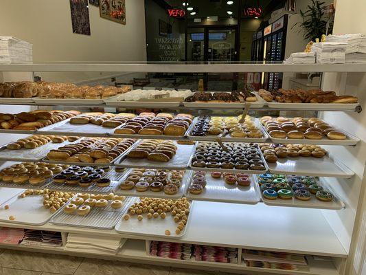 Variety of kolaches, breakfast croissant, breakfast taco and donuts.