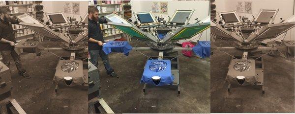 Talkingink custom t-shirts manual screen printing press in operation.