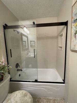 (G) AFTER- New tub and sliding doors.