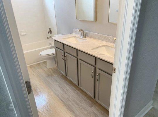 Guest Bathroom Upgrade with new cabinet colors, hardware, flooring and mirrors.