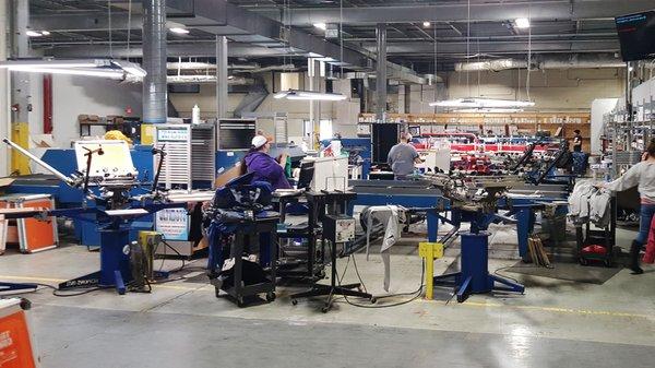 Screen printing custom t-shirts on the first shift.