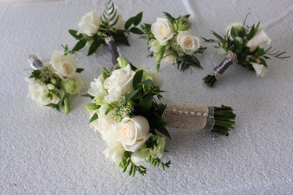 Bridal party bouquets with lace details and pearls. Wedding flowers for the new Mrs.