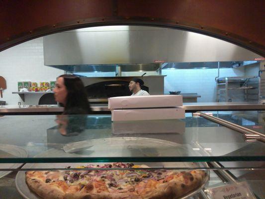 One of the Pizza Chefs in the background! He's great! And the woman helping to move everything along is pretty cool too!