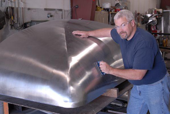 Stephen polishing a roof panel for train car.