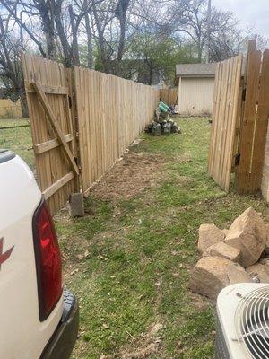 Wood 6' Provacy Fence featuring Two Custom Gates and Leveled Ground for Water Runoff