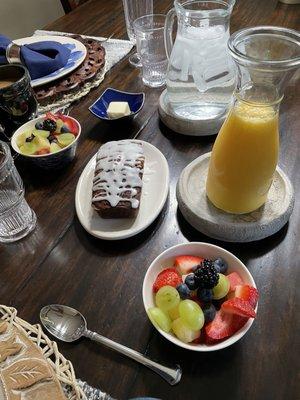 Fresh fruit, juice and baked goods with breakfast.