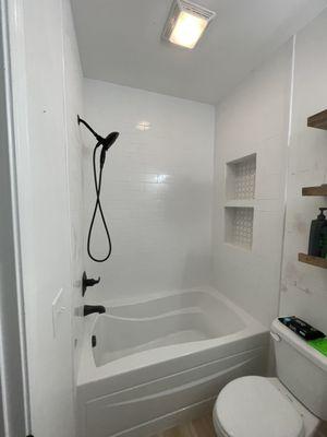 Guest bathroom tub replacement and tile installation and shelving for Pam