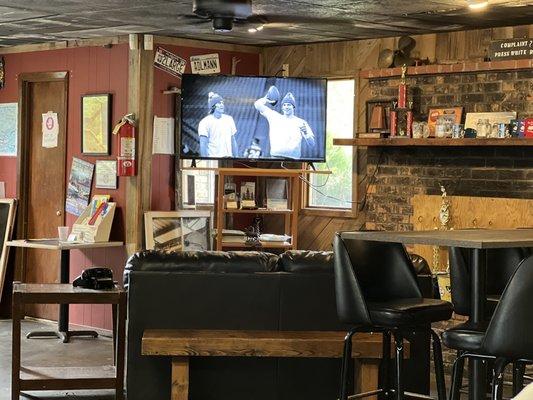 The main entrance with a leather couch and tv, what more would you want next to the bar while waiting to be seated...