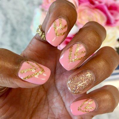 Mai does an awesome job with fun nail designs! Linen Pink w/ gold glitter chevron pattern.